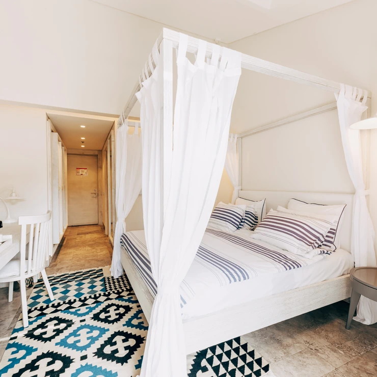 Attic Room at D Resort Gocek with canopy bed and bright top-floor design