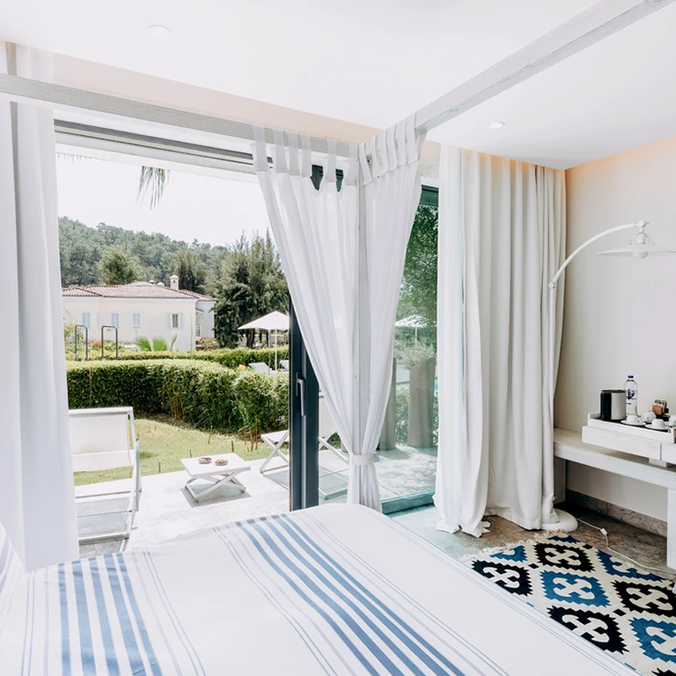 Superior Room at D Resort Gocek with canopy bed opening onto the pool