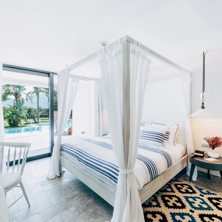 Presidential Suite at D Resort Gocek with canopy bed opening onto the pool
